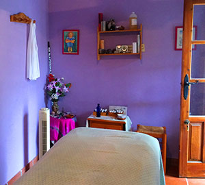 Purple walled massage room at Cortijo Romero